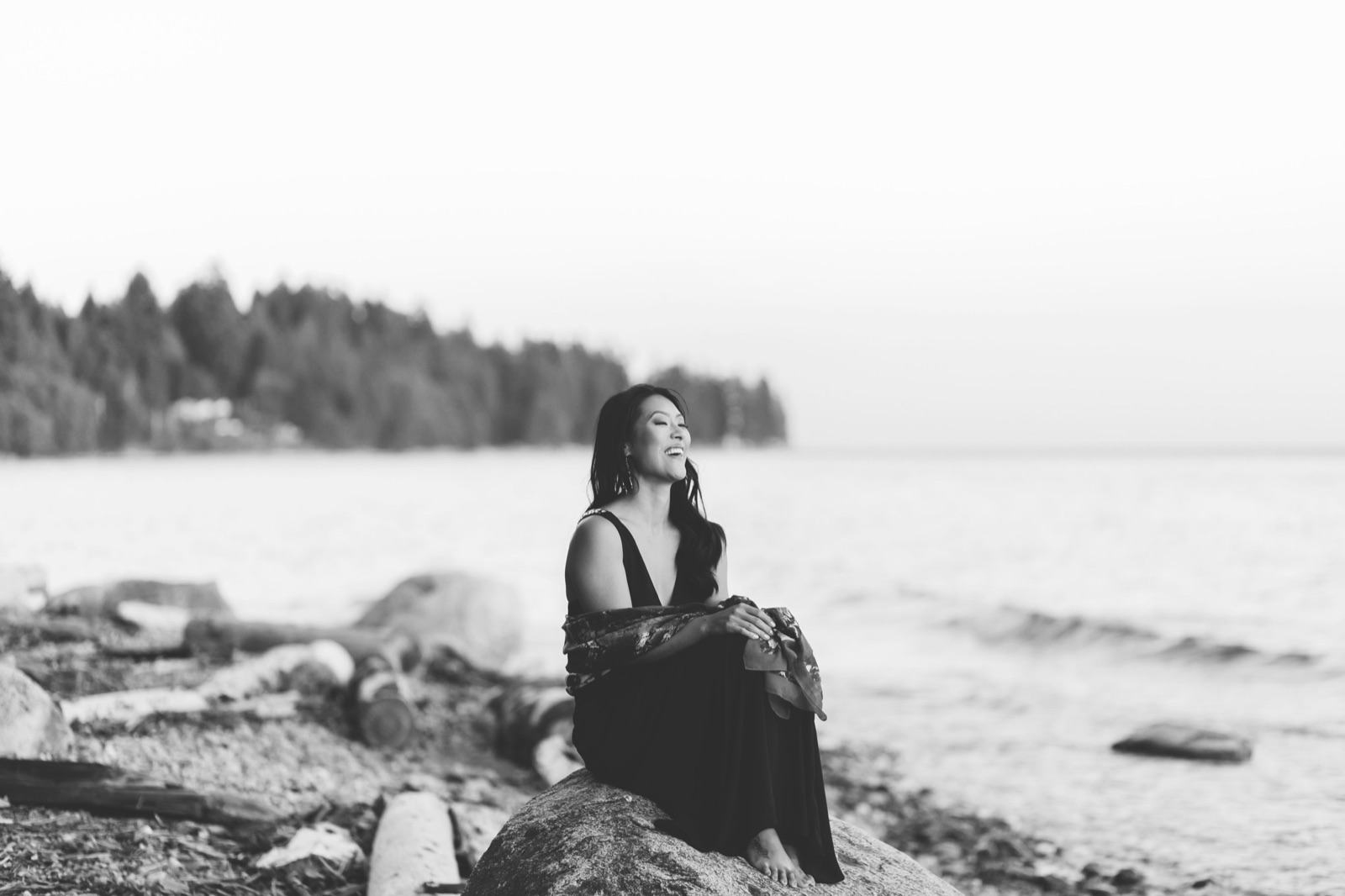 Elfina Luk laughing by the water — every camera confidence zone is a stop on the same path